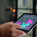 Trainer tracking client progress with digital tablet.