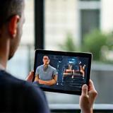 Coach providing online training demonstration via tablet.