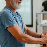 Trainer assisting client with rehabilitation and mobility exercises.